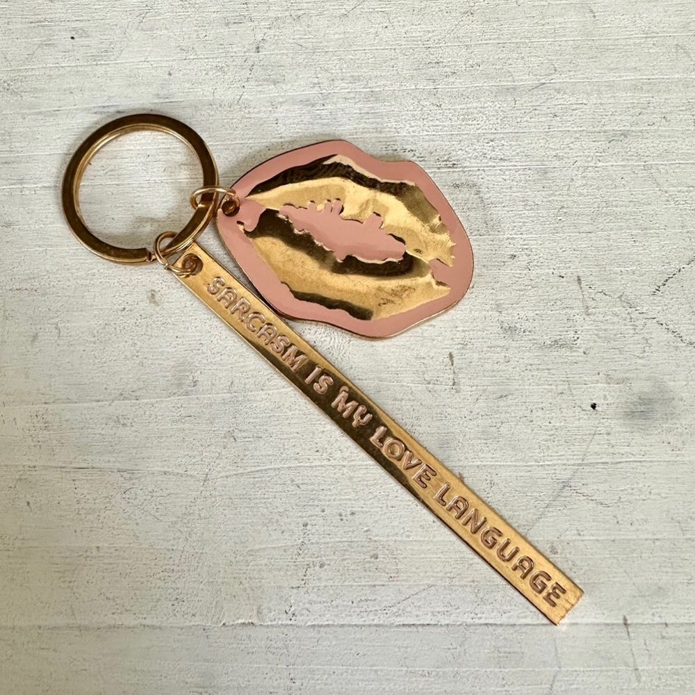Lips keychain that says “ Sarcasm is my Love language “